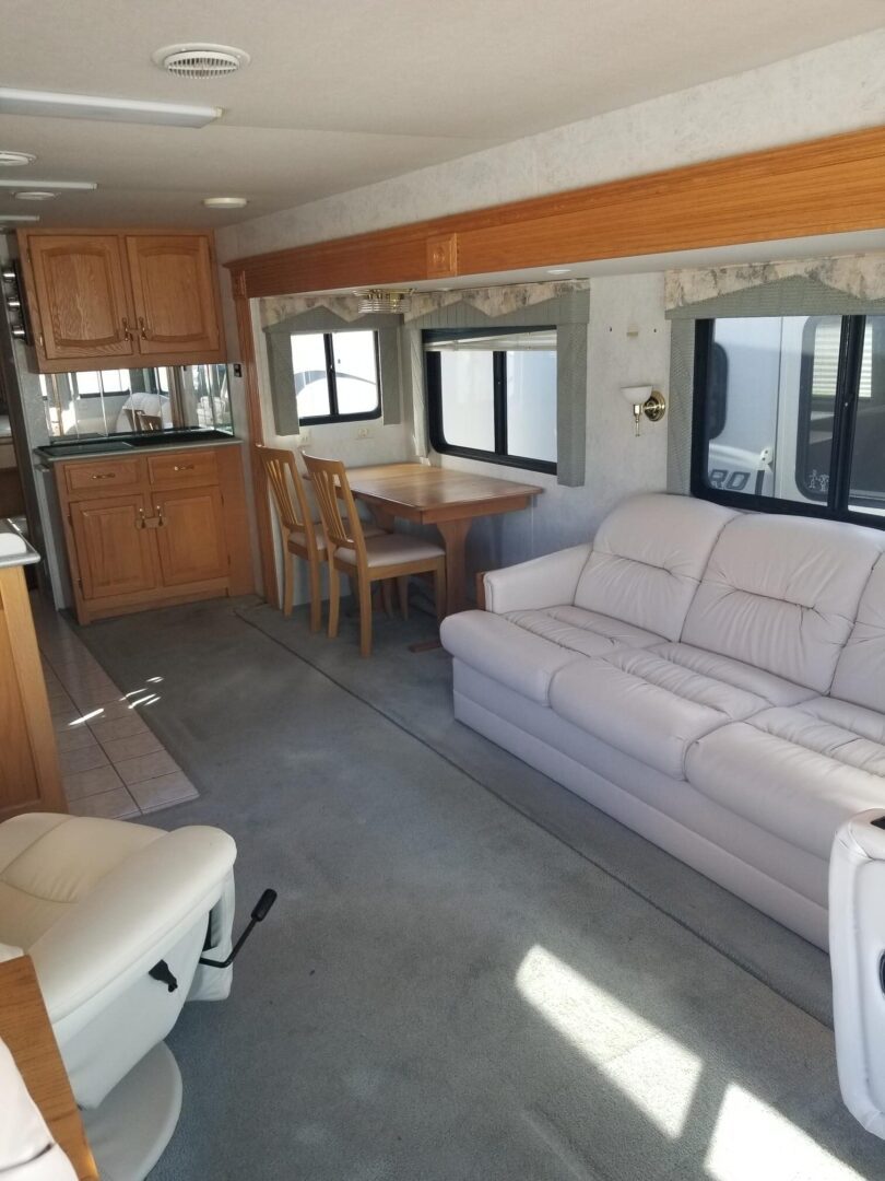 An rv with a kitchen and living room.