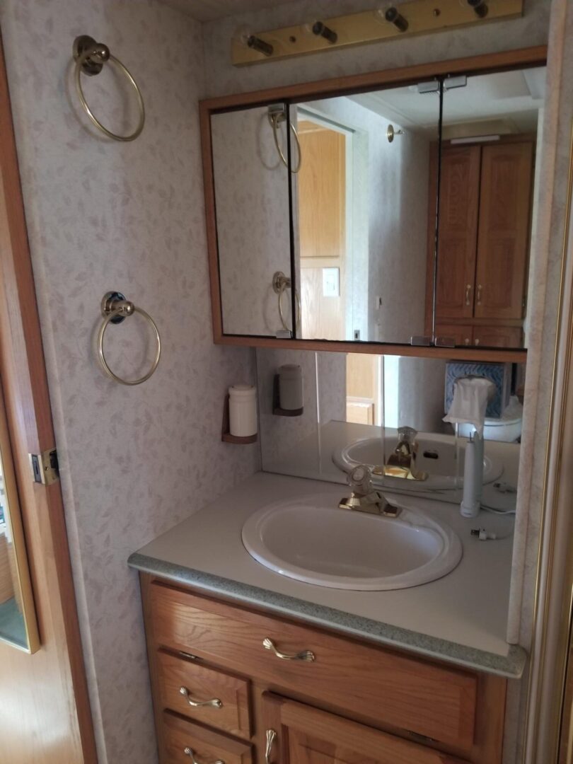 A small bathroom with a sink and mirror.