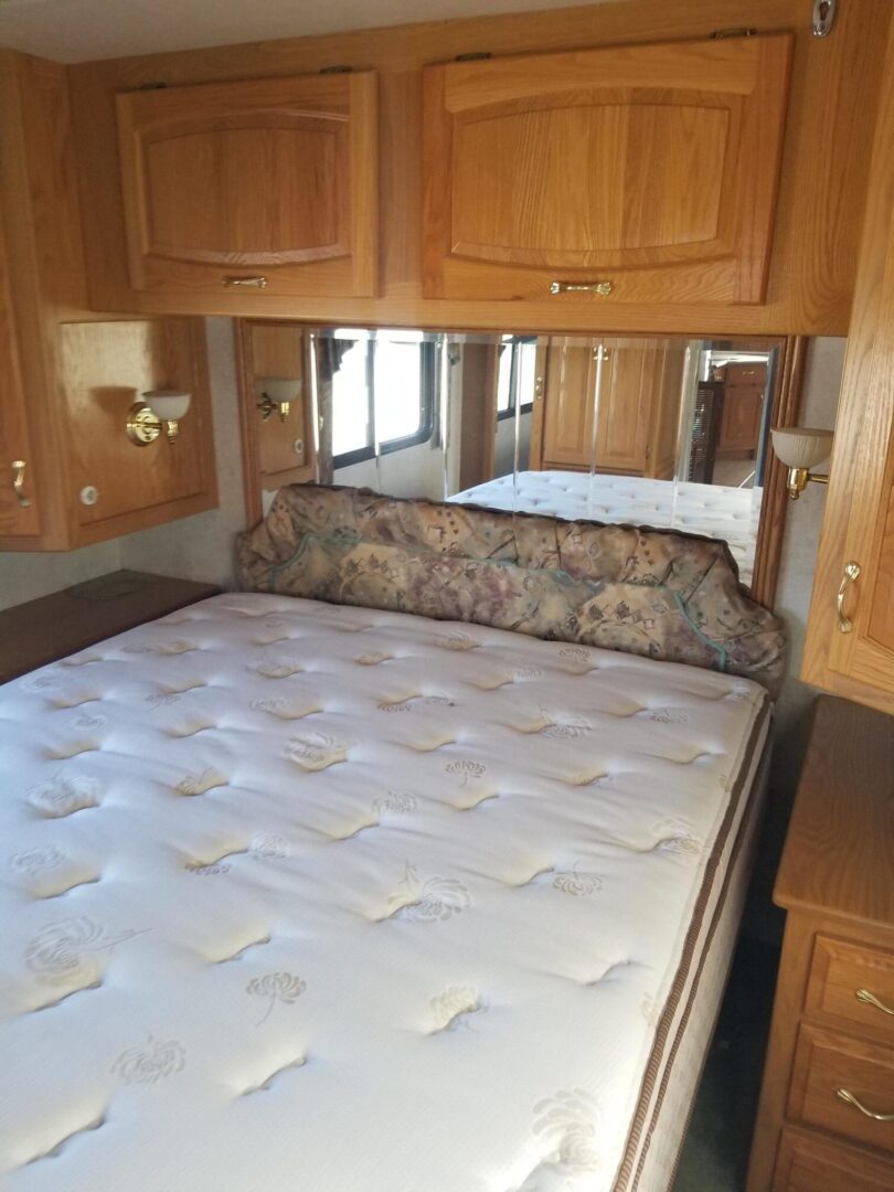 An rv with a bed in the middle of the room.