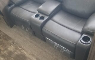 A grey couch and recliner in a rv.