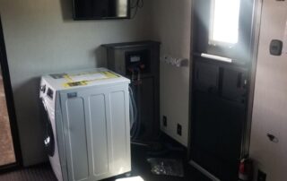 The inside of an rv with a washer and dryer.