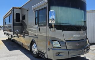 Gray Vectra motorhome parked outdoors.