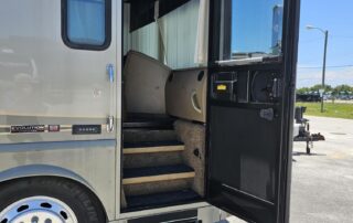 RV entrance with steps and open door.