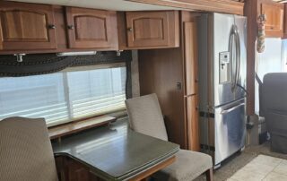 RV interior with table and chairs.