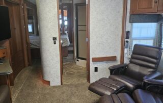 Interior of a luxury RV with two chairs.