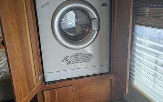 White washer and dryer in RV cabinet.