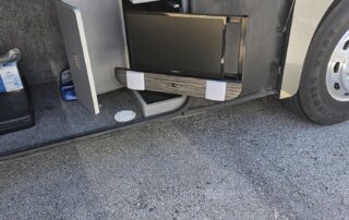 TV and stereo in RV storage compartment.