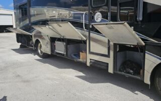 Allegro Bus parked with storage open