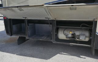 RV storage compartments with propane tank.