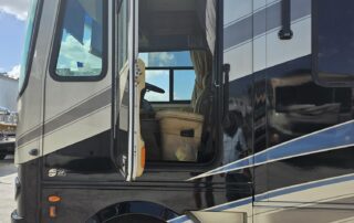 Black and silver RV with open door.