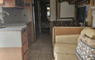 RV interior with kitchen and couch.