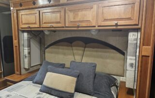 Bed with pillows in RV bedroom.