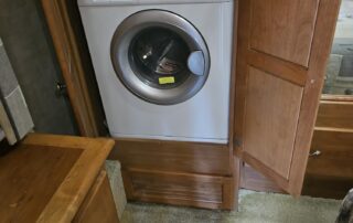 White washer in a wooden cabinet.