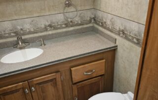 Bathroom with sink, toilet, and cabinets.